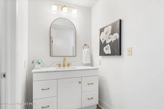 a view of a backyard with a large tree and wooden fence