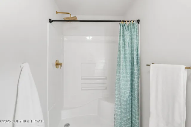 a backyard of a house with wooden deck and barbeque oven