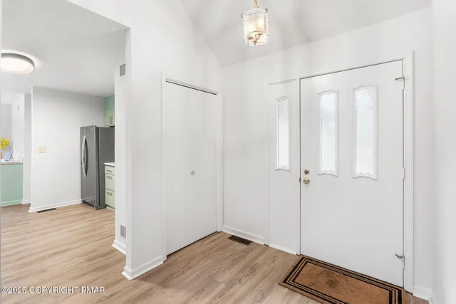 a living room with furniture a large window and a dining table