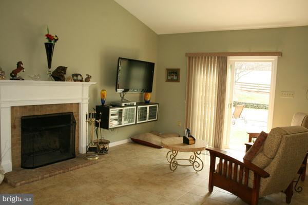 13130 Brandon Way Road Gaithersburg, MD 20878 - Photo 11 of 26 a living room with furniture and a fireplace