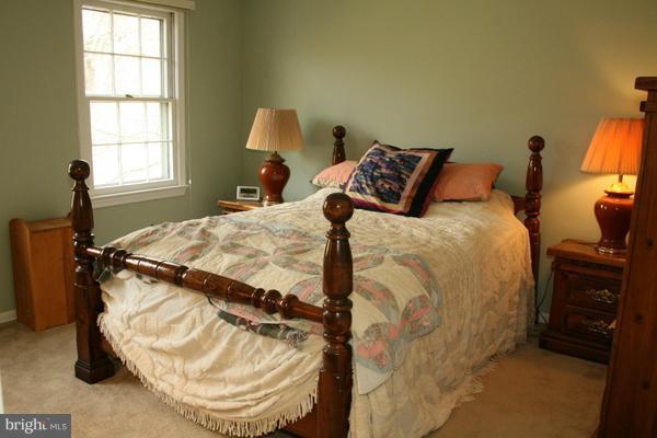 13130 Brandon Way Road Gaithersburg, MD 20878 - Photo 14 of 26 a bedroom with a bed and wooden floor