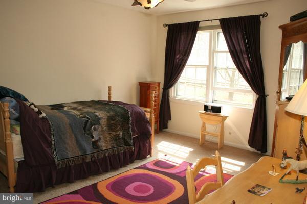 13130 Brandon Way Road Gaithersburg, MD 20878 - Photo 18 of 26 a bed sitting in a bedroom next to a window