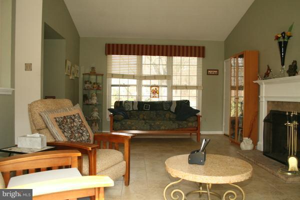 13130 Brandon Way Road Gaithersburg, MD 20878 - Photo 5 of 26 a living room with furniture and a fireplace