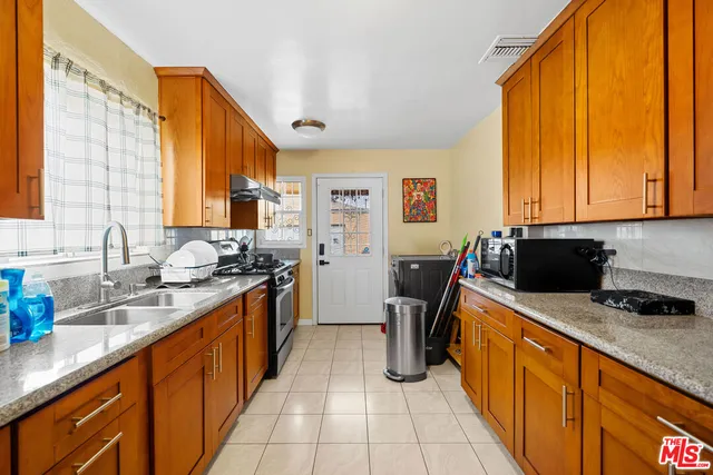 a kitchen with stainless steel appliances a refrigerator sink and cabinets