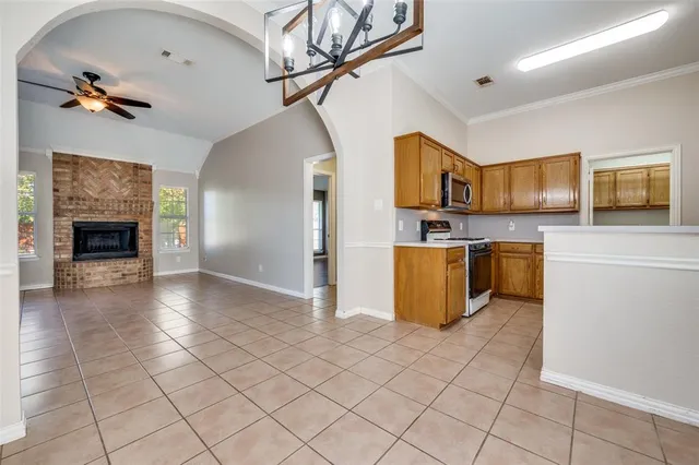 a kitchen with stainless steel appliances granite countertop a refrigerator and a stove top oven