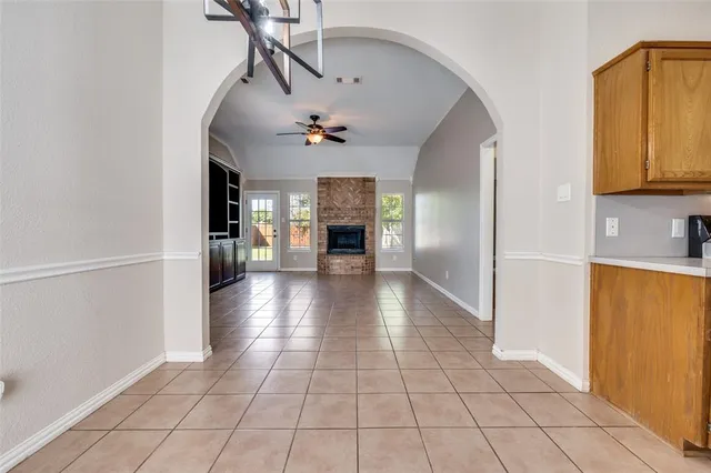 a view of a hallway with wooden floor and a living room