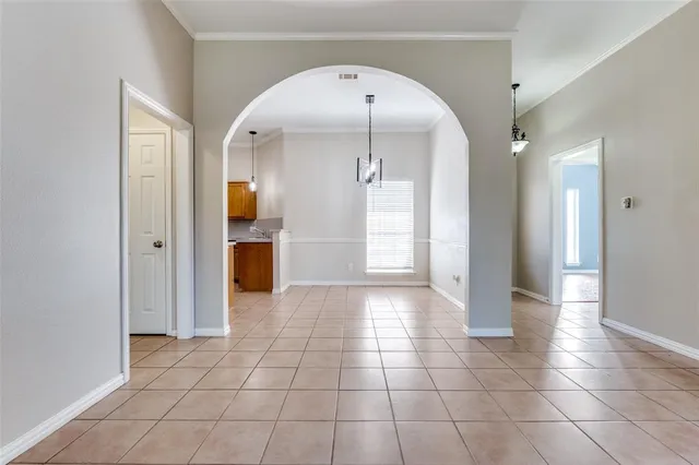 a view of a hallway with wooden floor and cabinet
