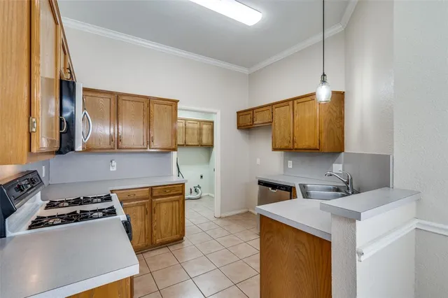 a kitchen that has a sink and a stove