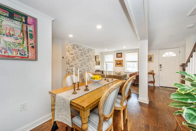 a dining room with furniture and wooden floor