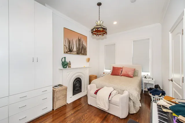 a bedroom with a bed and a fireplace