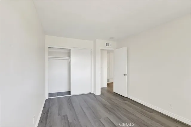 a view of an empty room and wooden floor