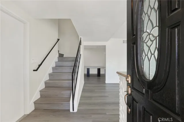 a view of a hallway with wooden floor and entryway