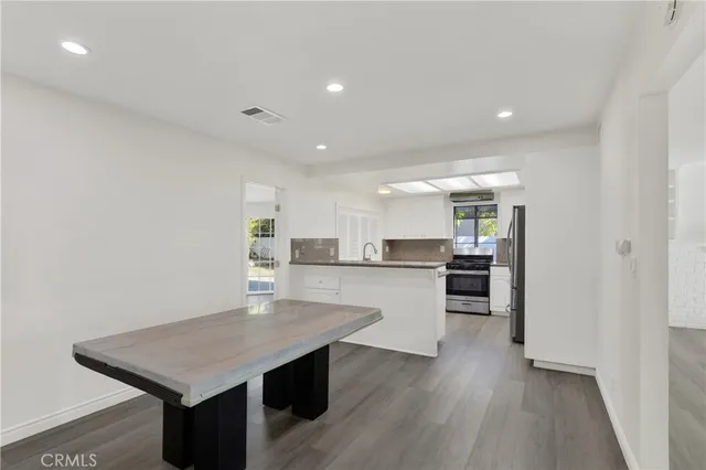 a kitchen with a table and chairs