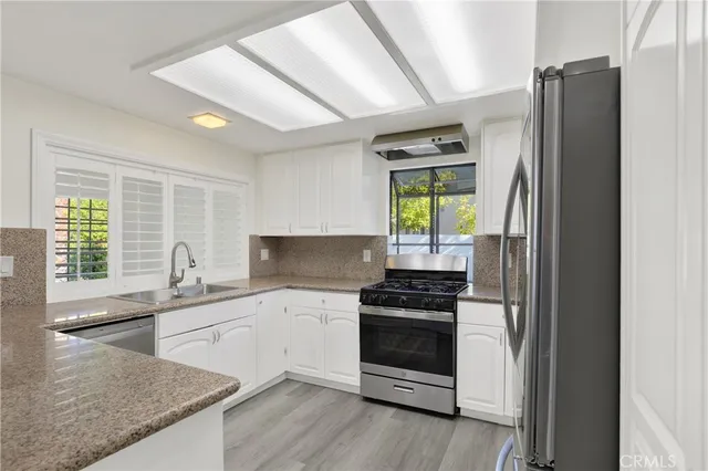 a kitchen with a sink stove and refrigerator