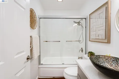 a bathroom with a shower a toilet and a shower