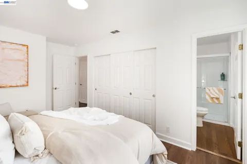 a bedroom with a bed and a mirror