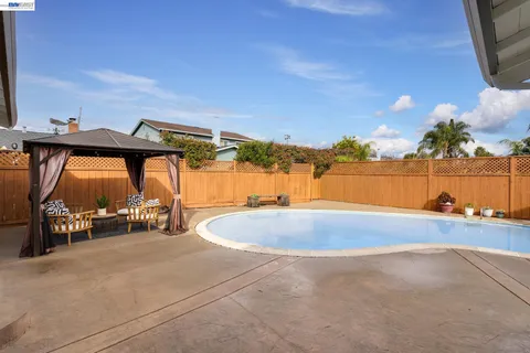 a backyard of a house with table and chairs