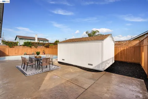 a view of a backyard with sitting area