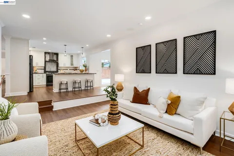 a living room with furniture and kitchen view