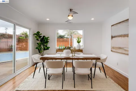 a dining room with furniture window and wooden floor