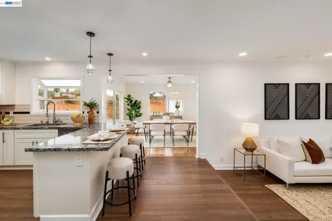 a living room with furniture and kitchen view