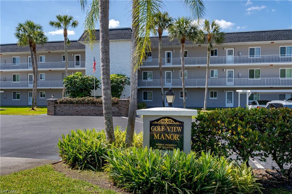 5515 Rattlesnake Hammock Road, Unit 205 Naples, FL 34113 - Photo 44 of 46 a front view of a building with garden
