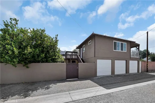 a front view of a house with plants