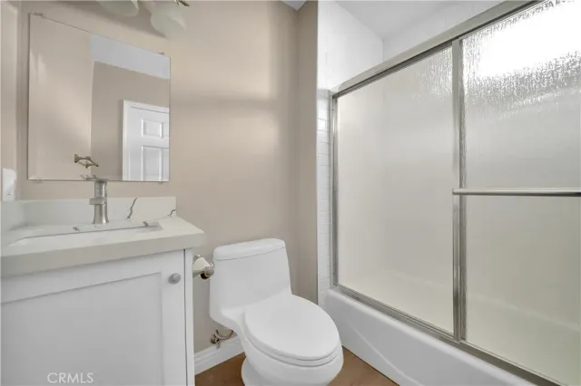 a bathroom with a toilet a sink and a mirror