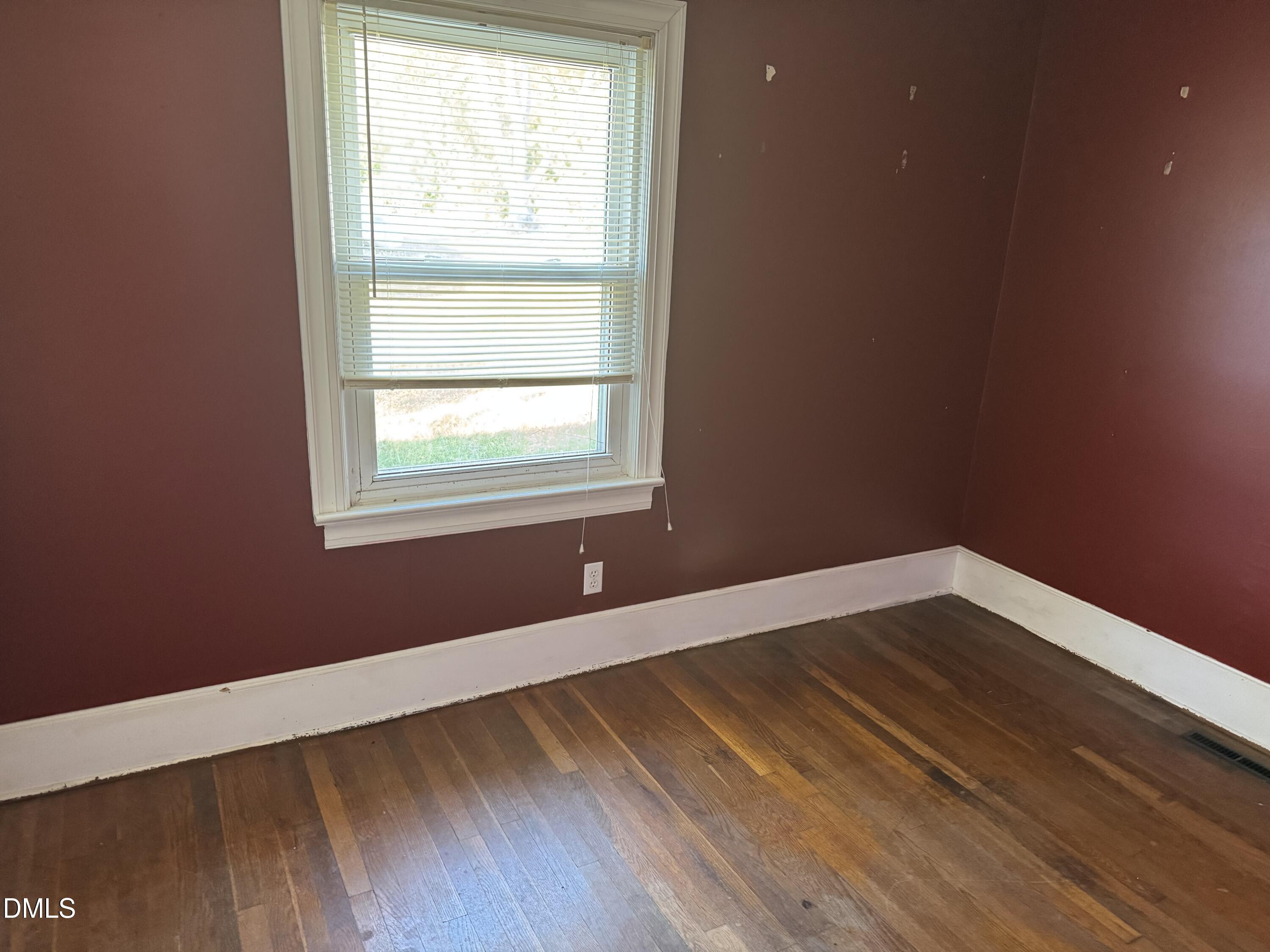 15008 Creedmoor Road Wake Forest, NC 27587 - Photo 5 of 14 a view of an empty room with wooden floor and a window