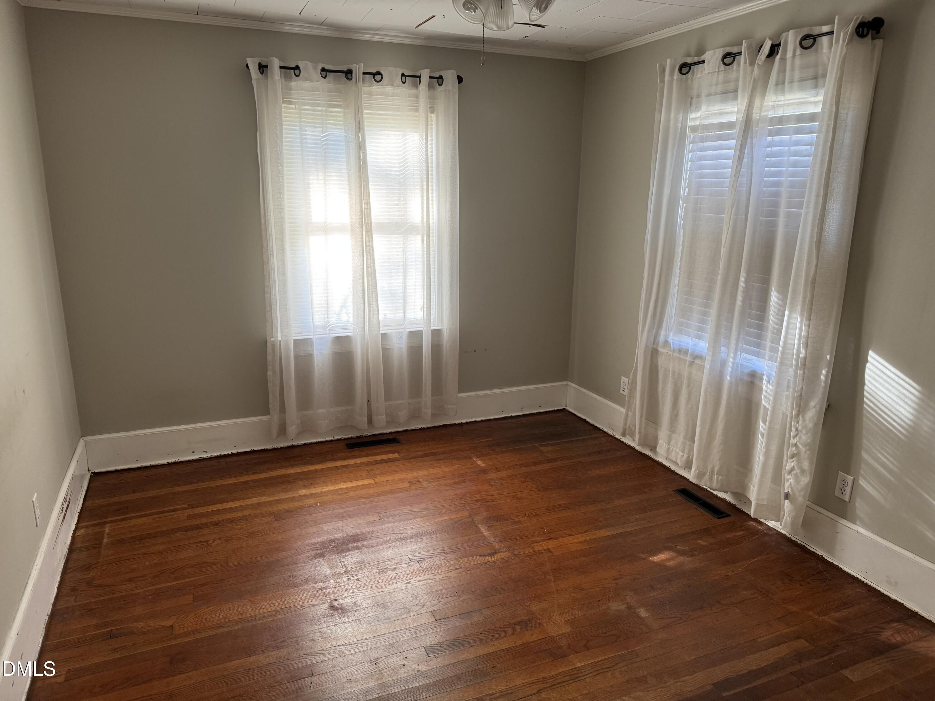 15008 Creedmoor Road Wake Forest, NC 27587 - Photo 6 of 14 an empty room with wooden floor and windows
