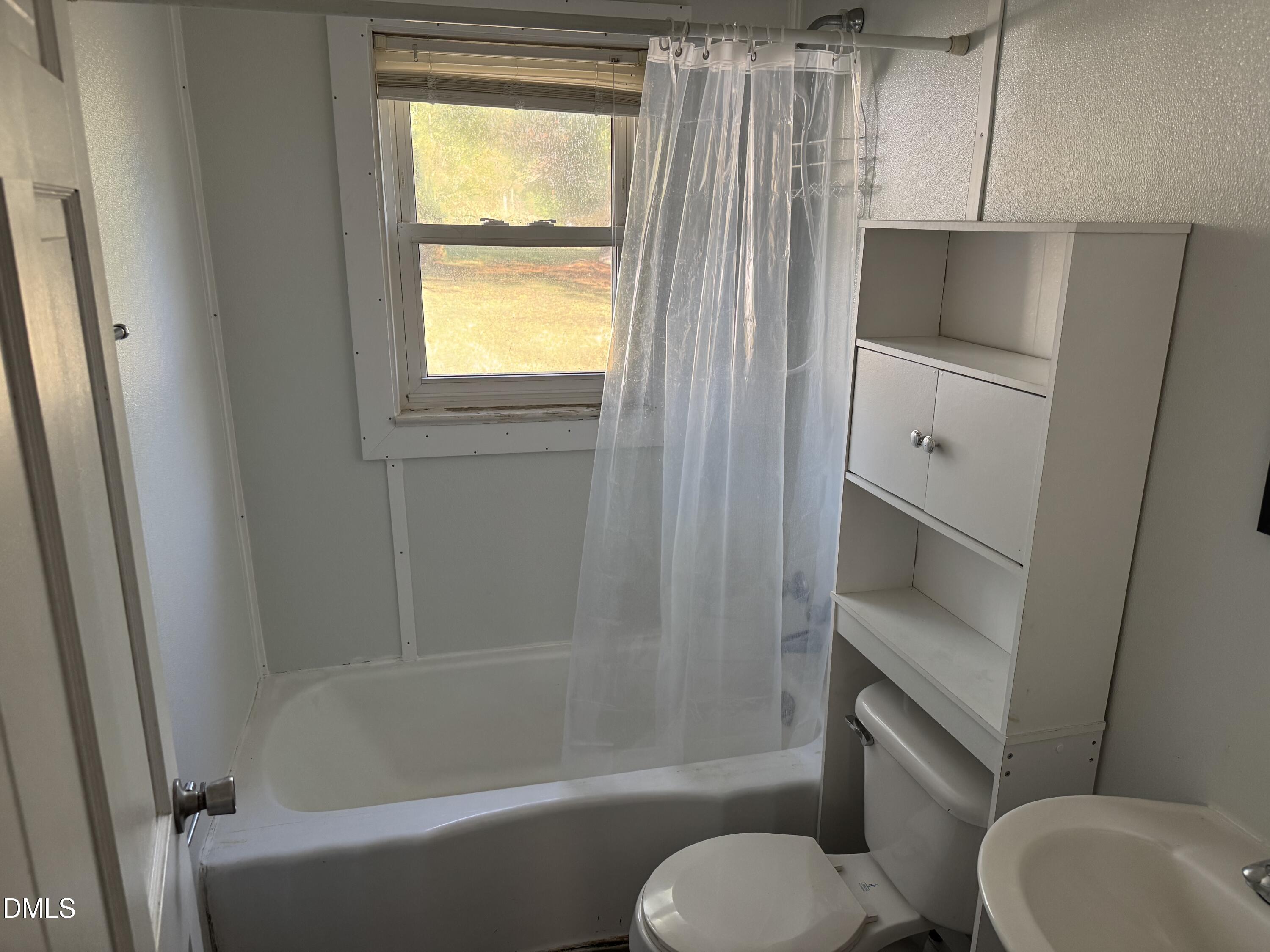 15008 Creedmoor Road Wake Forest, NC 27587 - Photo 8 of 14 a bathroom with a sink toilet and shower