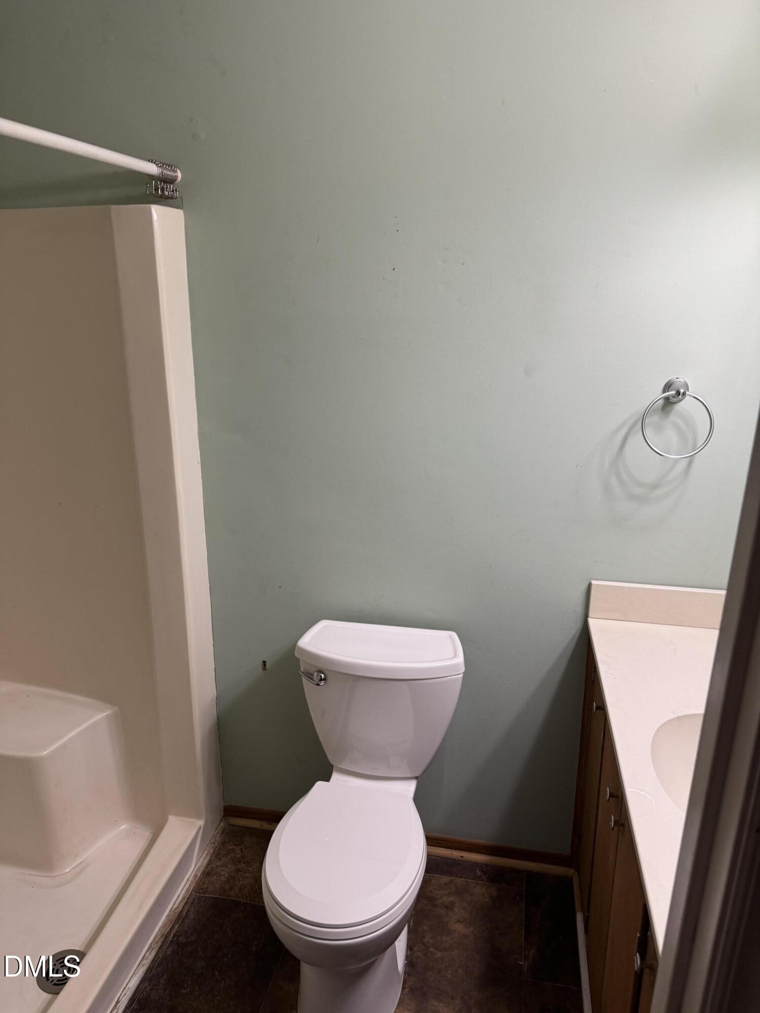 15008 Creedmoor Road Wake Forest, NC 27587 - Photo 9 of 14 a white toilet sitting next to a bathroom sink