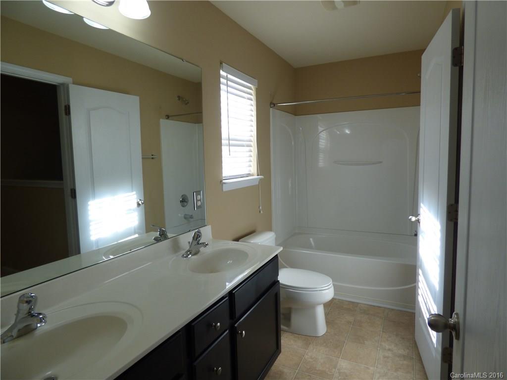 1249 Afternoon Sun Road Matthews, NC 28104 - Photo 19 of 20 a bathroom with a double vanity sink toilet and shower