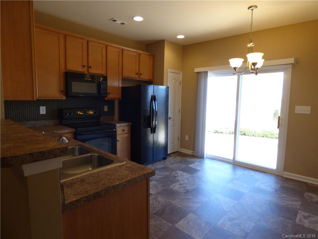 1249 Afternoon Sun Road Matthews, NC 28104 - Photo 5 of 20 a kitchen with kitchen island a counter space cabinets and stainless steel appliances