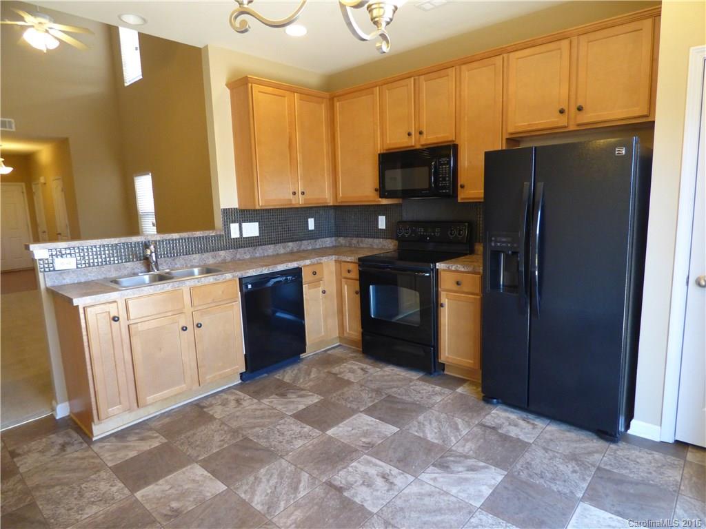 1249 Afternoon Sun Road Matthews, NC 28104 - Photo 6 of 20 a kitchen with stainless steel appliances granite countertop a stove a sink dishwasher and a refrigerator
