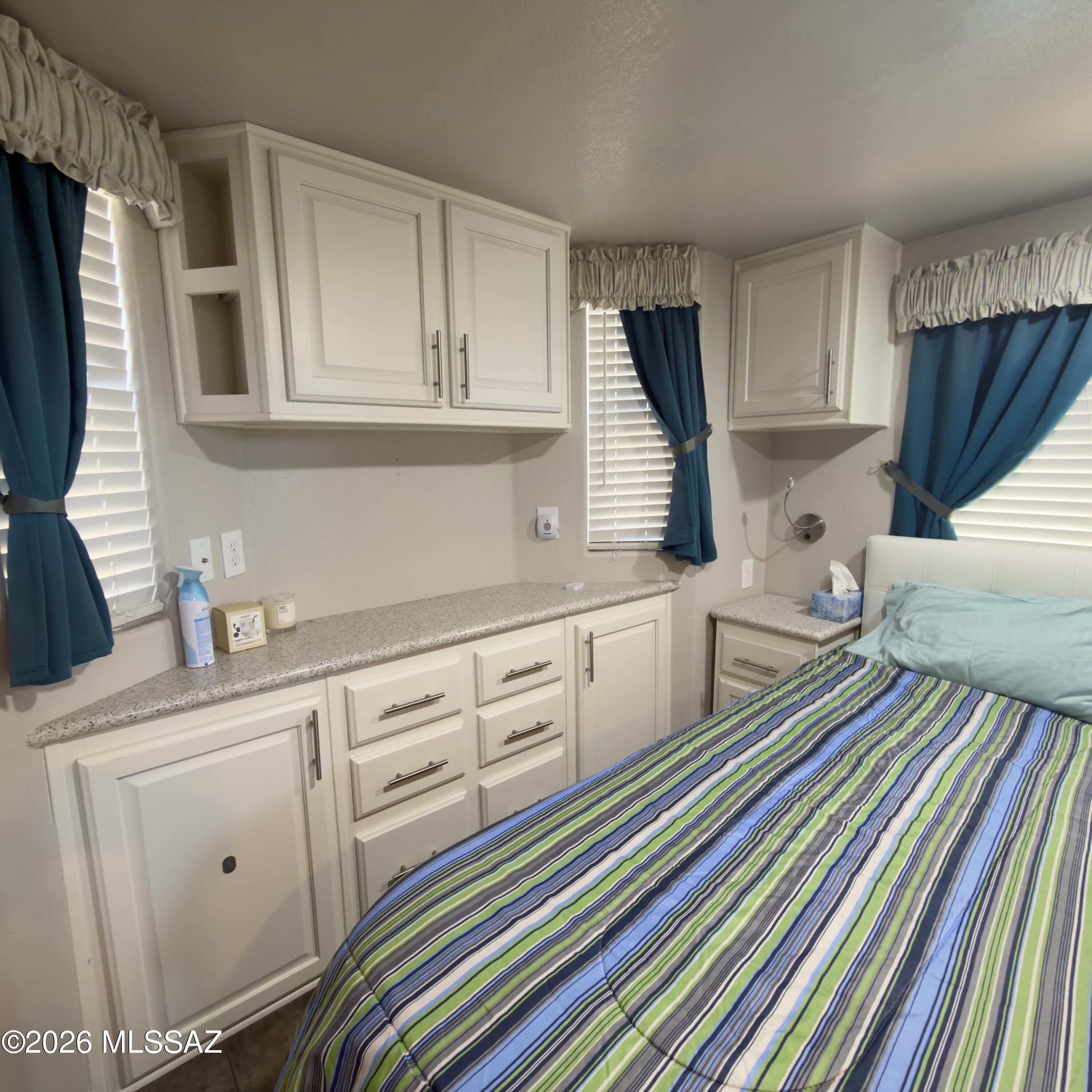 2843 19 Interstate 19 Frontage Road, Unit 116 Amado, AZ 85645 - Photo 13 of 32 a kitchen with white cabinets and appliances