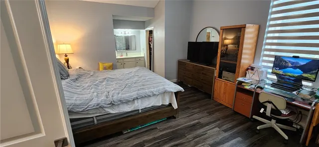 a bed sitting in a bedroom next to a window