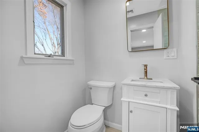 a bathroom with a sink a vanity and mirror