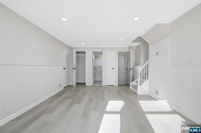 a bathroom with a granite countertop toilet and a sink