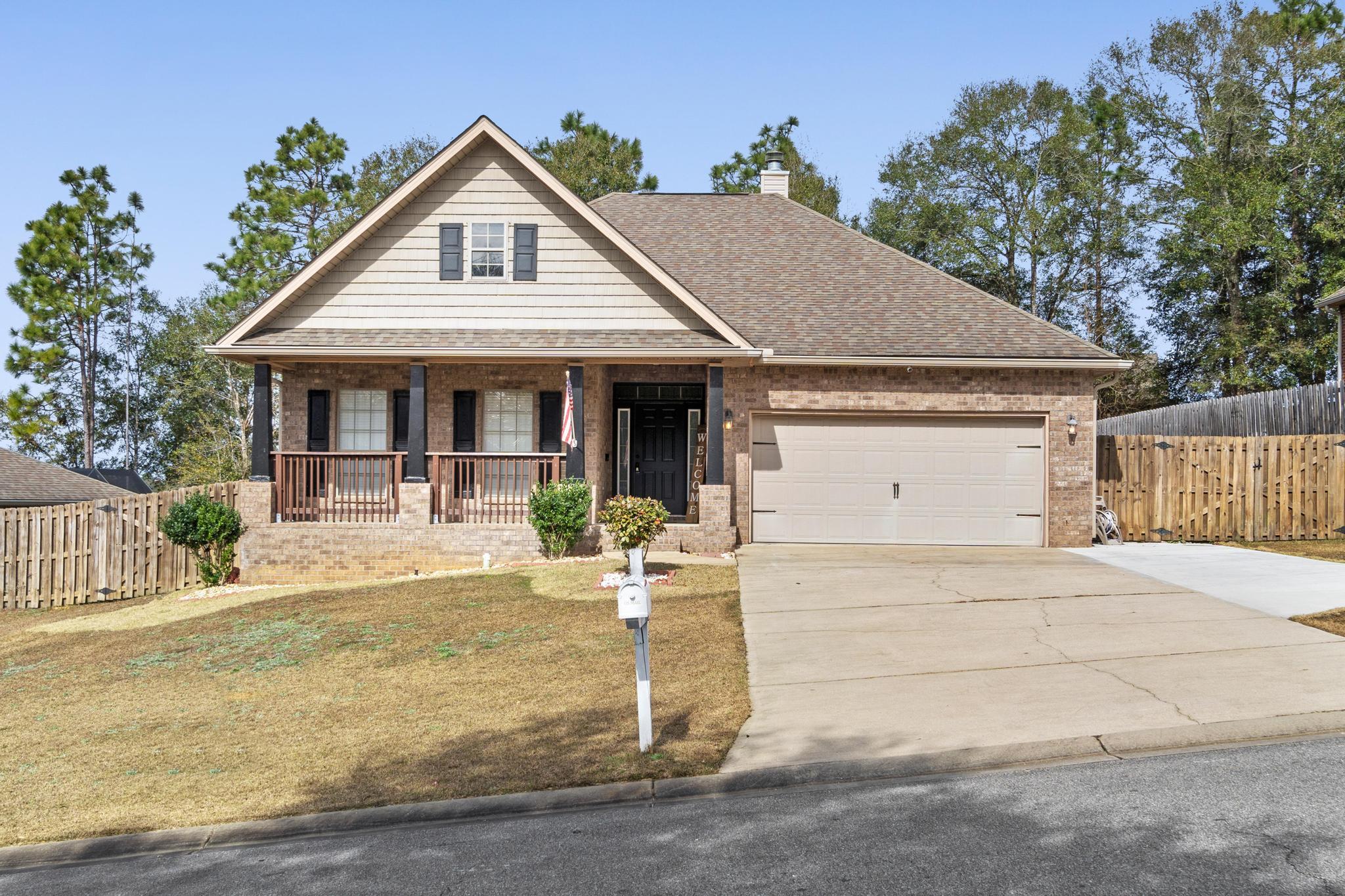 641 Red Fern Road Crestview, FL 32536 - Photo 1 of 33 a front view of a house with garden