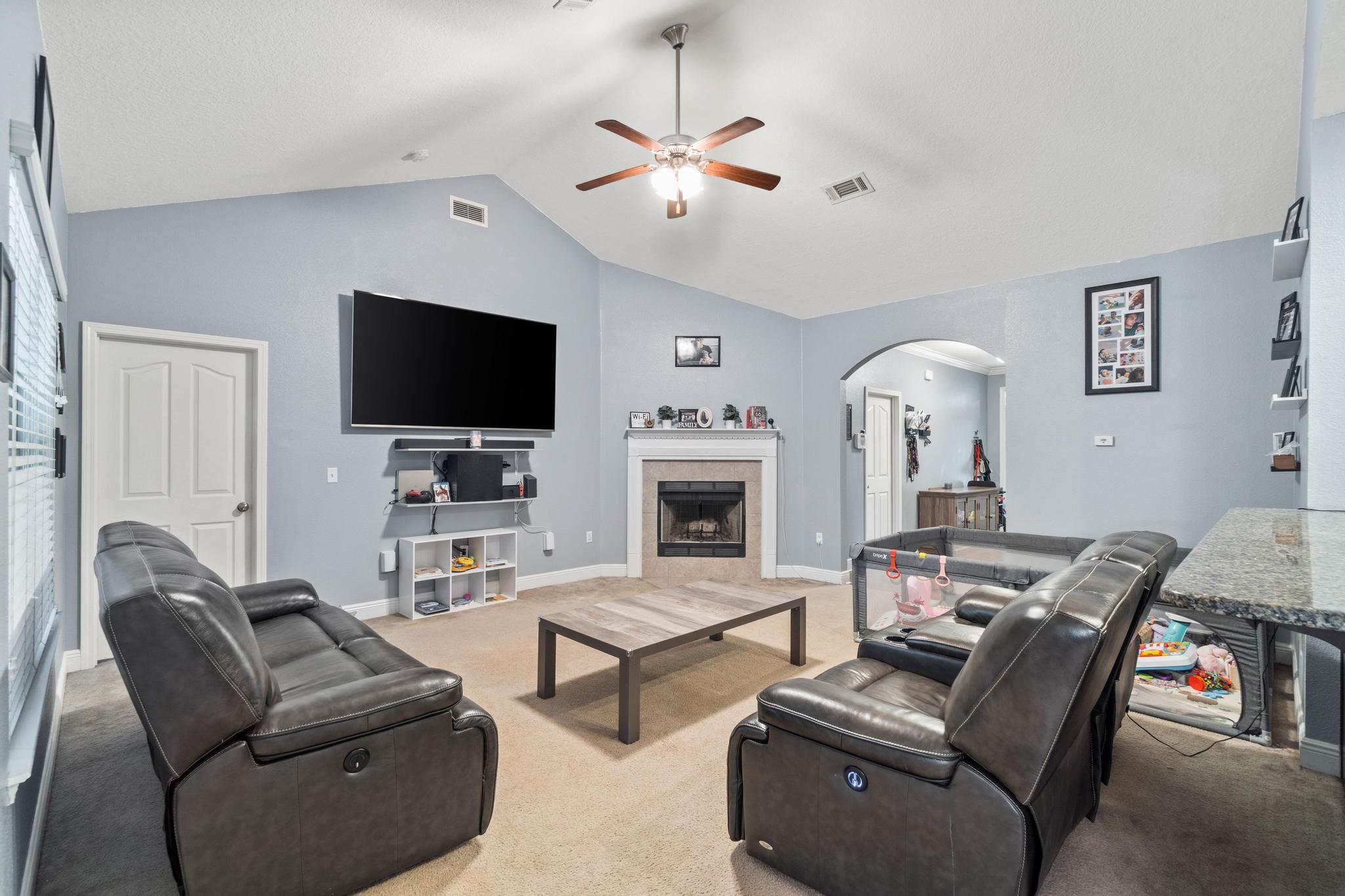 641 Red Fern Road Crestview, FL 32536 - Photo 14 of 33 a living room with furniture a flat screen tv and a fireplace