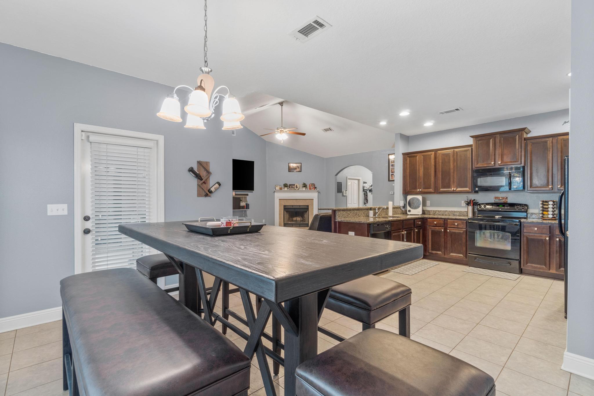 641 Red Fern Road Crestview, FL 32536 - Photo 17 of 33 a kitchen with a dining table chairs stainless steel appliances and cabinets