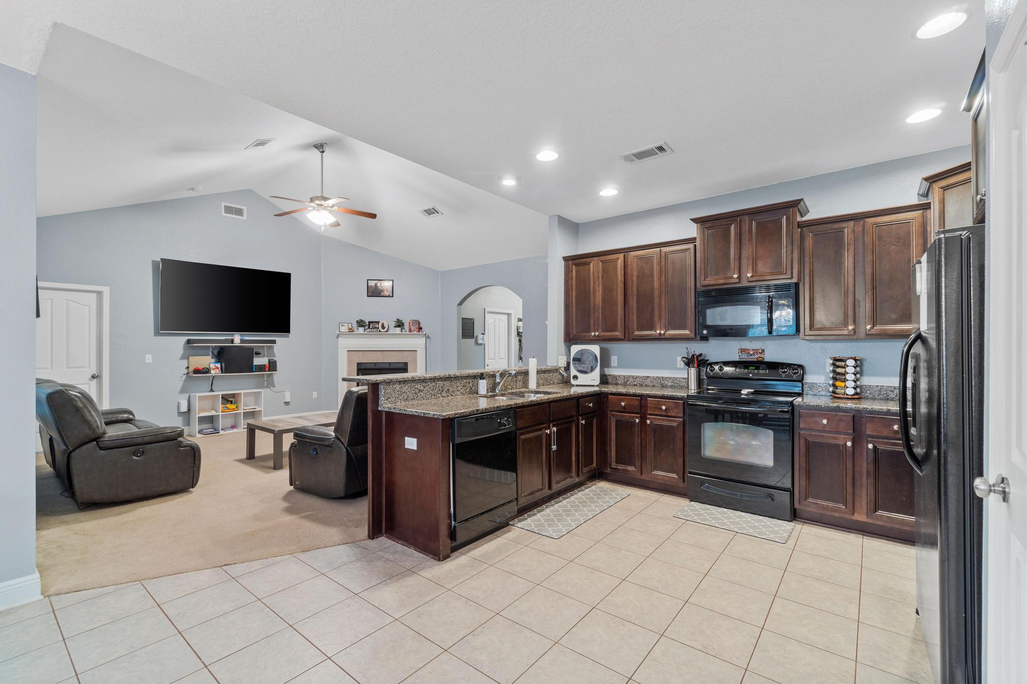 641 Red Fern Road Crestview, FL 32536 - Photo 18 of 33 a kitchen with stainless steel appliances granite countertop a refrigerator and a stove top oven