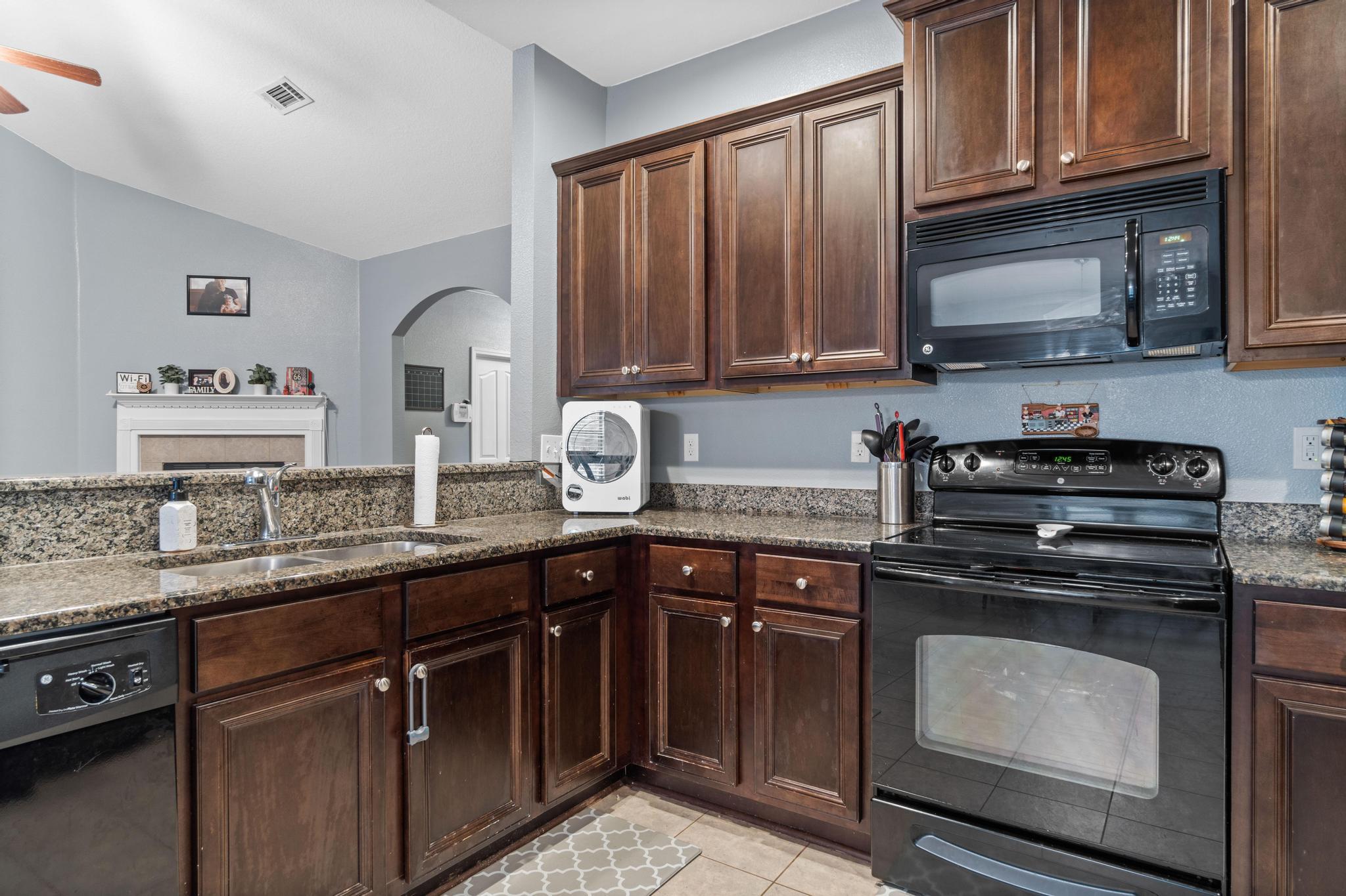 641 Red Fern Road Crestview, FL 32536 - Photo 19 of 33 a kitchen with granite countertop stainless steel appliances stove top oven and cabinets