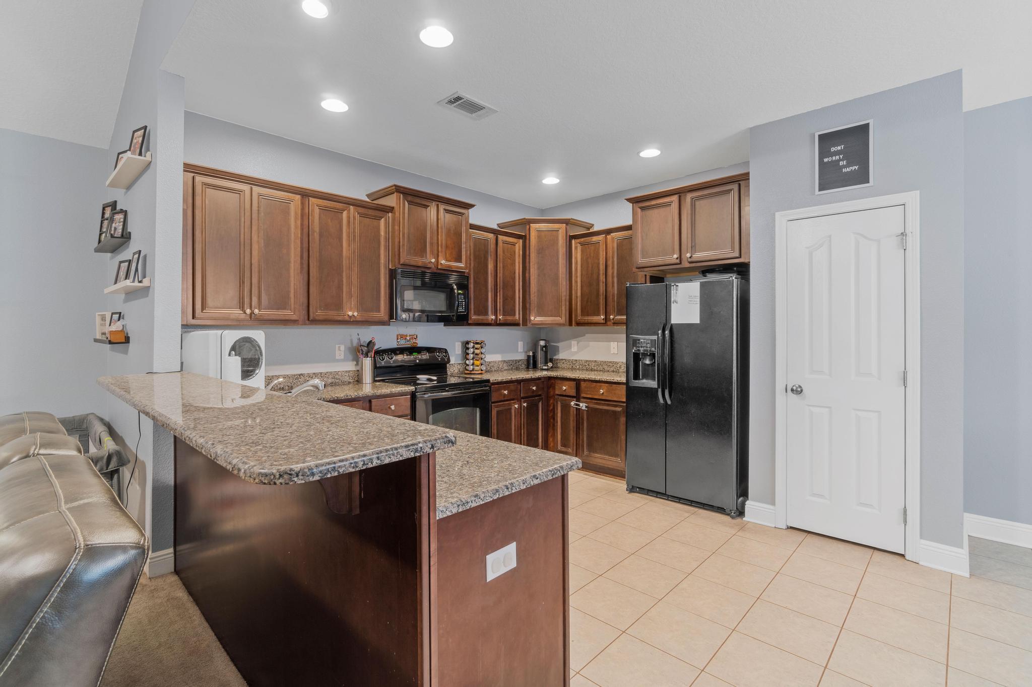641 Red Fern Road Crestview, FL 32536 - Photo 21 of 33 a kitchen with kitchen island granite countertop stainless steel appliances cabinets a sink and a counter top space