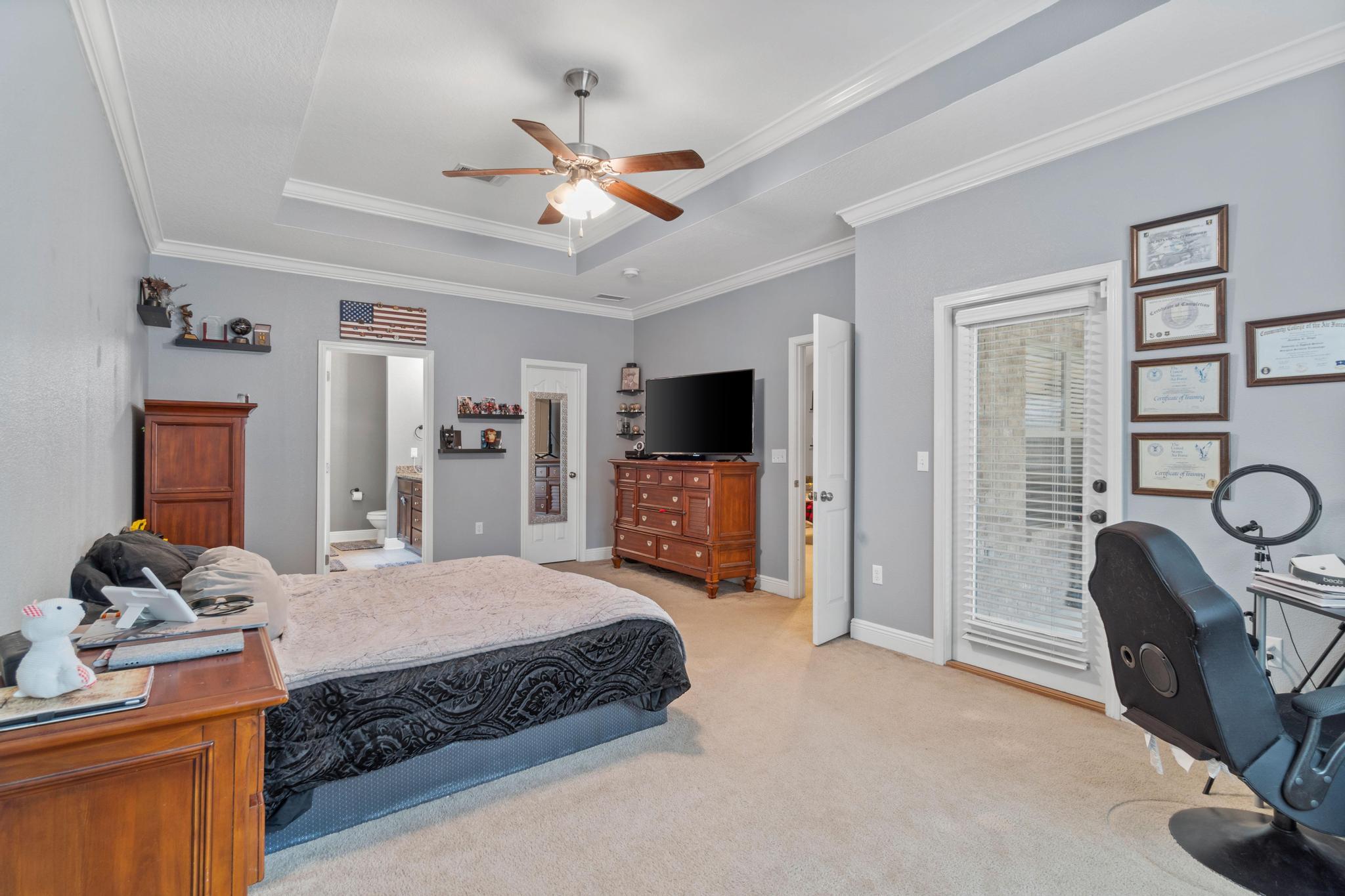641 Red Fern Road Crestview, FL 32536 - Photo 23 of 33 a bedroom with a bed and a flat tv screen on dresser