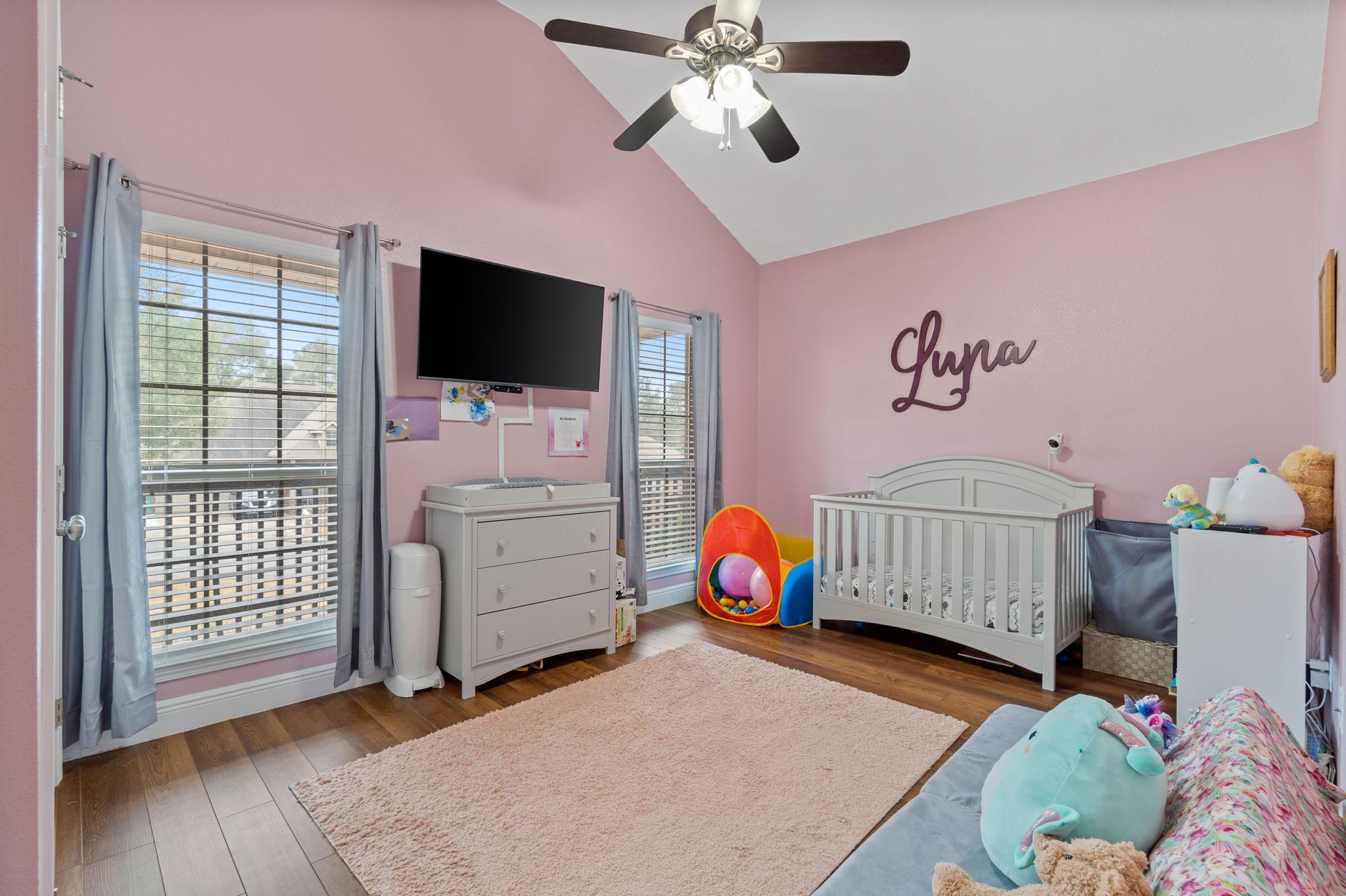 641 Red Fern Road Crestview, FL 32536 - Photo 7 of 33 a bedroom with furniture and a flat screen tv
