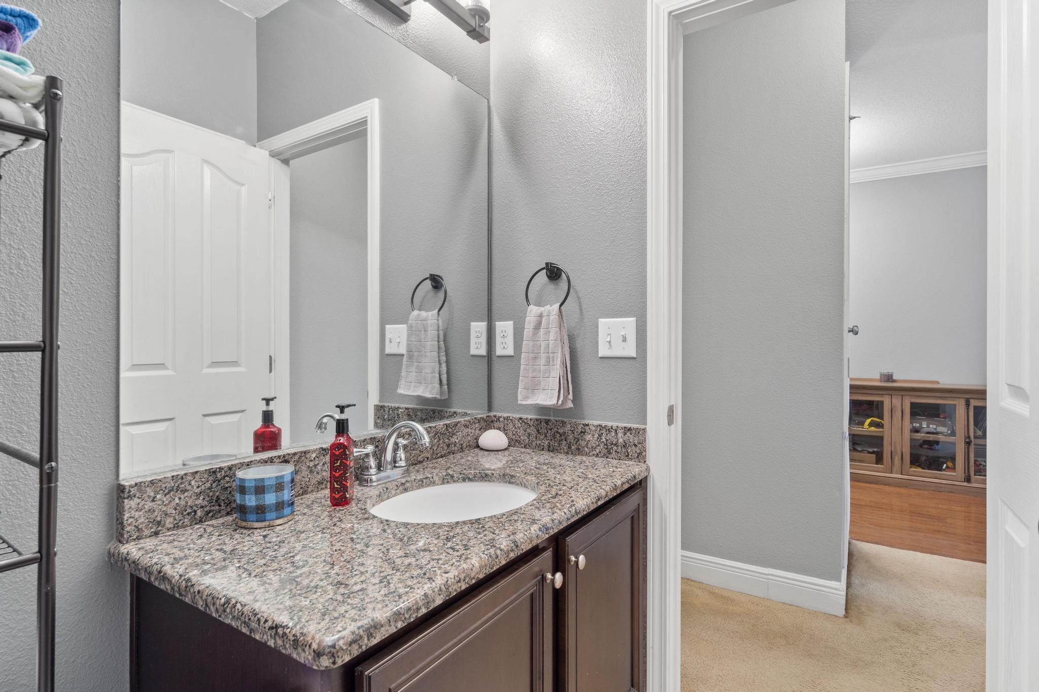 641 Red Fern Road Crestview, FL 32536 - Photo 10 of 33 a bathroom with sink granite and a mirror