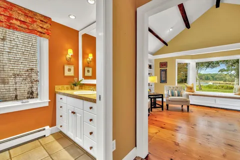 a bedroom with a bed and a large window