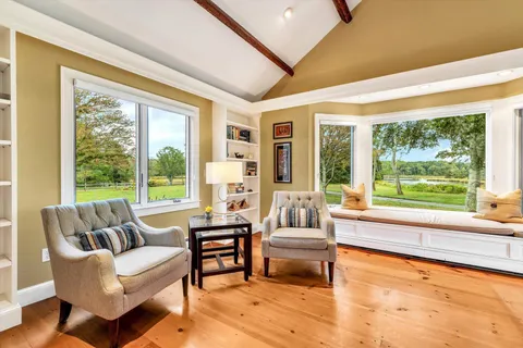 a living room with a large window and a table